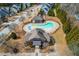 Aerial view of a community pool and recreational area with seating and play structures at 761 Wickham Ridge Rd, Apex, NC 27539