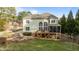 Expansive backyard featuring an exterior elevation, large deck, and stone patio area at 7709 Moondance Ct, Wake Forest, NC 27587