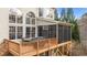 Large deck featuring a screened in porch with a dining table and an outdoor cooking area at 7709 Moondance Ct, Wake Forest, NC 27587