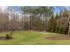 Large backyard with mature trees and manicured lawn at 7709 Moondance Ct, Wake Forest, NC 27587