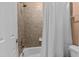 Bathroom features tiled shower and tub with white shower curtain at 7709 Moondance Ct, Wake Forest, NC 27587