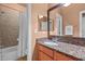 Bathroom with granite countertops, a large mirror, and a shower and tub combination at 7709 Moondance Ct, Wake Forest, NC 27587