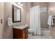 Cozy bathroom with tiled shower and tub combination and wood vanity with granite countertops at 7709 Moondance Ct, Wake Forest, NC 27587