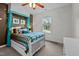 Bedroom with a canopy bed, accent wall, and window view at 7709 Moondance Ct, Wake Forest, NC 27587