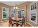 Dining area featuring a wooden table, chandelier and multiple windows providing lots of natural light at 7709 Moondance Ct, Wake Forest, NC 27587
