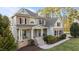Beautiful exterior view of a two-story home with a welcoming front porch and manicured landscaping at 7709 Moondance Ct, Wake Forest, NC 27587