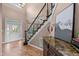 Bright foyer featuring a staircase, white trim and beautiful marble-topped furniture at 7709 Moondance Ct, Wake Forest, NC 27587