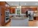 Bright kitchen with granite countertops, stainless steel appliances and dark wood cabinets at 7709 Moondance Ct, Wake Forest, NC 27587