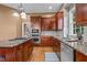 Stylish kitchen features granite countertops, stainless steel appliances, and wood floors at 7709 Moondance Ct, Wake Forest, NC 27587