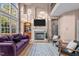 Sunlit living area showcases a fireplace, high ceilings, and comfortable seating for relaxation at 7709 Moondance Ct, Wake Forest, NC 27587