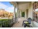 A shady porch with comfy chair provides a place to relax with a view of the neighborhood at 7709 Moondance Ct, Wake Forest, NC 27587