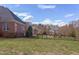 Well-kept backyard with a manicured lawn, outlined by a sleek black metal fence providing security and curb appeal at 9041 Chelsea Dr, Raleigh, NC 27603