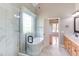 Bright bathroom with a glass shower, marble tile, and view to the Primary bedroom at 9041 Chelsea Dr, Raleigh, NC 27603