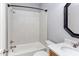 Bathroom featuring shower and tub with granite countertop and framed mirror at 9041 Chelsea Dr, Raleigh, NC 27603