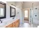 Elegant bathroom with double sinks, a marble countertop, and a luxurious glass shower at 9041 Chelsea Dr, Raleigh, NC 27603