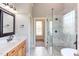 Modern bathroom with a marble countertop, dark fixtures, and a glass-enclosed shower at 9041 Chelsea Dr, Raleigh, NC 27603
