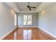 Spacious bedroom featuring hardwood floors, a tray ceiling, and plenty of natural light at 9041 Chelsea Dr, Raleigh, NC 27603