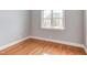 Cozy bedroom with hardwood floors and a bright window, perfect for relaxing at 9041 Chelsea Dr, Raleigh, NC 27603