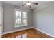 Bedroom with hardwood floors, large window, and neutral color palette at 9041 Chelsea Dr, Raleigh, NC 27603