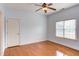 This light blue bedroom features a window, ceiling fan, and hardwood floors at 9041 Chelsea Dr, Raleigh, NC 27603