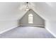 Bonus room features an arched window, neutral walls and gray carpet at 9041 Chelsea Dr, Raleigh, NC 27603