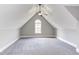 Bonus room features an arched window, neutral walls and gray carpet at 9041 Chelsea Dr, Raleigh, NC 27603