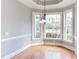 Sun-filled breakfast nook with custom chandelier and large windows overlooking backyard at 9041 Chelsea Dr, Raleigh, NC 27603