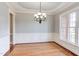 Elegant dining room featuring chair rail, hardwood floors, crown molding and a decorative chandelier at 9041 Chelsea Dr, Raleigh, NC 27603