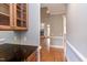 Hallway with hardwood floors, trim, and granite counter for drink storage at 9041 Chelsea Dr, Raleigh, NC 27603