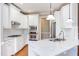 Modern kitchen features stainless appliances, marble countertops, and white cabinets at 9041 Chelsea Dr, Raleigh, NC 27603