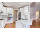 Open kitchen with stainless steel appliances, marble countertops, and hardwood floors at 9041 Chelsea Dr, Raleigh, NC 27603