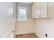 Well-lit laundry room with custom shelving and a window at 9041 Chelsea Dr, Raleigh, NC 27603