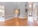 Open living room featuring hardwood floors, neutral walls, and staircase at 9041 Chelsea Dr, Raleigh, NC 27603