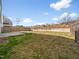 Backyard with a concrete patio, fence and overgrown foliage at 932 Peninsula Pl, Knightdale, NC 27545