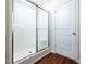 Bathroom shower stall with glass sliding door and wood look floor at 932 Peninsula Pl, Knightdale, NC 27545