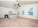 Spacious bedroom with neutral carpet, ceiling fan, large windows and base trim at 932 Peninsula Pl, Knightdale, NC 27545