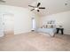 Spacious bedroom with neutral carpet, ceiling fan, large windows and base trim at 932 Peninsula Pl, Knightdale, NC 27545