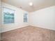 Bright bedroom featuring neutral carpet, two windows and white walls at 932 Peninsula Pl, Knightdale, NC 27545
