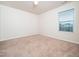 Bright bedroom featuring neutral carpet, a window and white walls at 932 Peninsula Pl, Knightdale, NC 27545