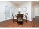 Bright dining area featuring wood floors, a round table with four chairs, and natural light from the adjacent door at 932 Peninsula Pl, Knightdale, NC 27545