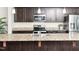 Close-up of a kitchen island with granite countertops and stainless steel appliances at 932 Peninsula Pl, Knightdale, NC 27545