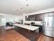Open-concept kitchen with dark cabinets, granite countertops, and stainless steel appliances at 932 Peninsula Pl, Knightdale, NC 27545