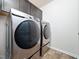 Laundry room showcasing stainless steel washer and dryer at 932 Peninsula Pl, Knightdale, NC 27545