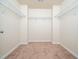 Walk-in closet featuring light walls, neutral carpet, and bright white wire shelving at 932 Peninsula Pl, Knightdale, NC 27545
