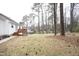 The backyard with a deck and mature trees at 104 Hickory Glen Ln, Durham, NC 27703