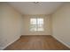 Bright bedroom features light walls, wood-look flooring, and a large window at 104 Hickory Glen Ln, Durham, NC 27703
