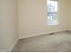 Bright bedroom with window and neutral carpet at 104 Hickory Glen Ln, Durham, NC 27703