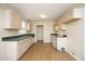 Functional kitchen with light wood cabinets, green countertops, and vinyl flooring at 104 Hickory Glen Ln, Durham, NC 27703