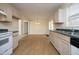 Open-concept kitchen features light wood cabinets, green countertops, and a view into the dining area at 104 Hickory Glen Ln, Durham, NC 27703