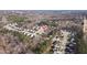 A birds eye view of the neighborhood showcasing many homes nestled within a serene wooded area at 105 Palladium Ct, Elon, NC 27244